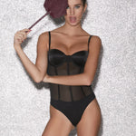 Model wearing white lace bodysuit – elegant lingerie NZ, perfect with suspenders, sheer stockings, and delicate lingerie sets.