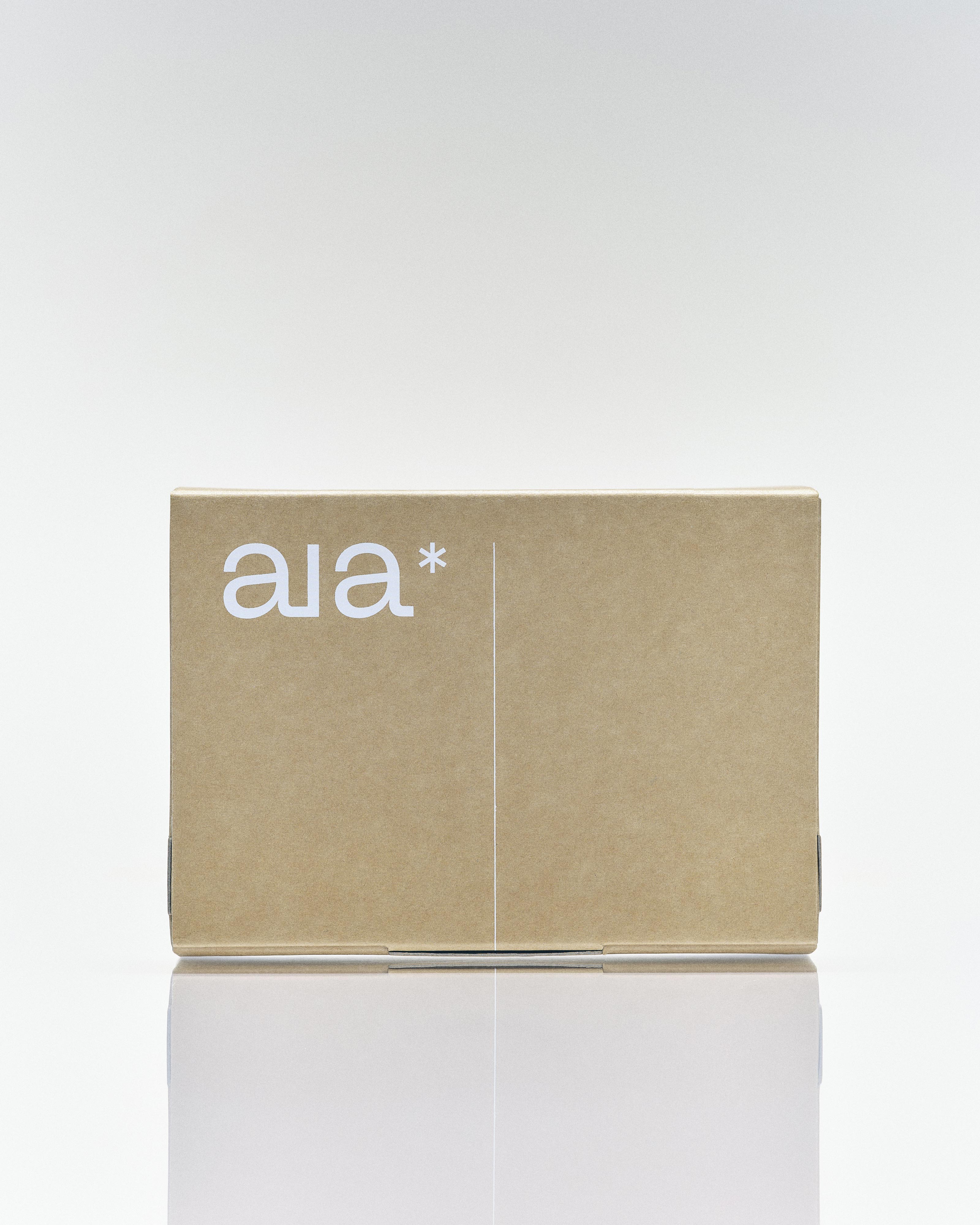 Aia Intimacy Essentials Box packaging featuring natural lubricant, massage oil, and stimulating gel in minimalist design.